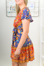 Load image into Gallery viewer, Our Free Spirit Floral Print Tiered Mini Dress is the Ideal Boho Piece. Pair this dress with some booties and a hat for the perfect Fall outfit.