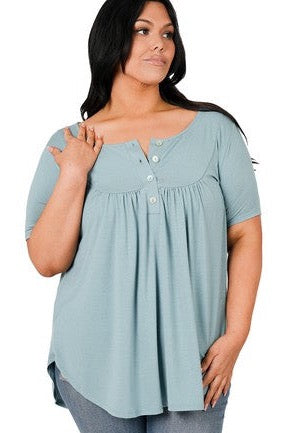 Our Creative Minds Short Sleeve Top is the ideal combination of classic meets quality. We are positive this will become one of your new closet favorites with its shirt tail hem and shell button detail!