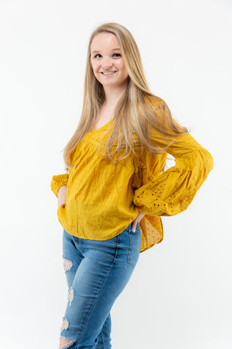 The Crochet Cut Out Mustard colored blouse will add the perfect pop of color to your Spring/Summer wardrobe! We think this top with some cutoff denim shorts and white booties will make the perfect casual girl outfit!