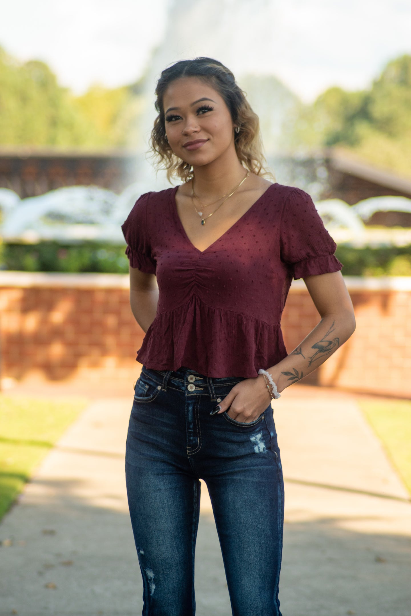 You're sure to love this wine colored baby doll top! There are so many dainty details to love! Match this top with a pair of black skinny jeans and black booties for an edgy look that is sure to turn heads!